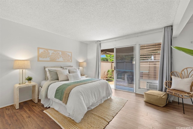 47-658 Hui Kelu St Unit 5, Kaneohe, HI 96744 - bedroom featuring access to exterior, wood finished floors, and a textured ceiling