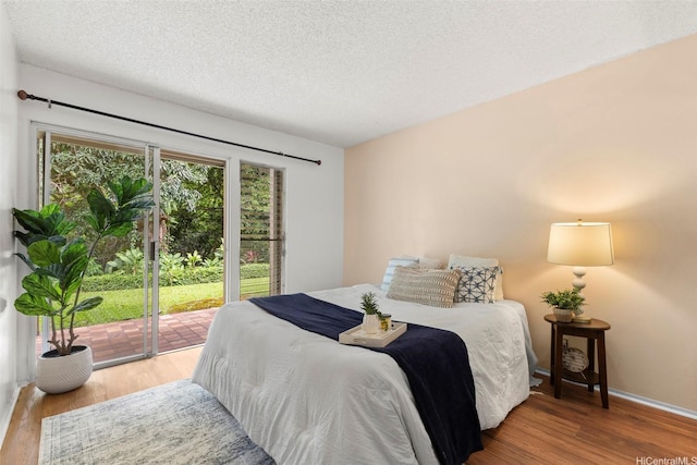 47-658 Hui Kelu St Unit 5, Kaneohe, HI 96744 - bedroom with access to outside, wood finished floors, and a textured ceiling