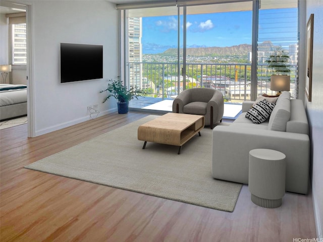 2439 Kapiolani Blvd Unit 1802, Honolulu, HI 96826 - living room with wood finished floors, floor to ceiling windows, and baseboards