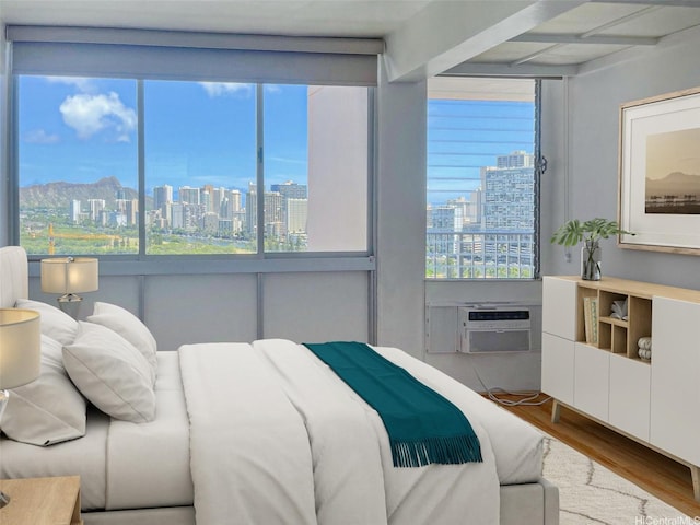 2439 Kapiolani Blvd Unit 1802, Honolulu, HI 96826 - bedroom featuring a skyline view, multiple windows, wood finished floors, beamed ceiling, and cooling unit