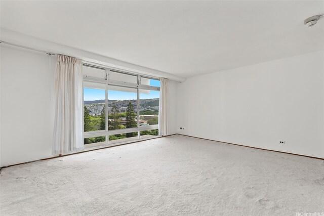 1519 Nuuanu Ave Unit 1044, Honolulu, HI 96817 - empty room with carpet flooring, a smoke detector, and expansive windows
