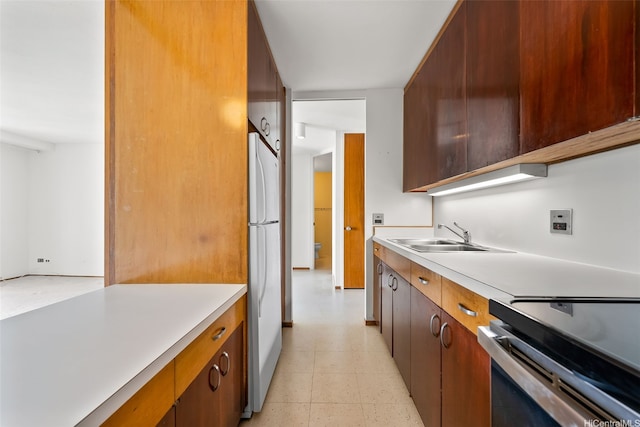 1519 Nuuanu Ave Unit 1044, Honolulu, HI 96817 - kitchen featuring a sink, freestanding refrigerator, light countertops, and stainless steel range with electric cooktop