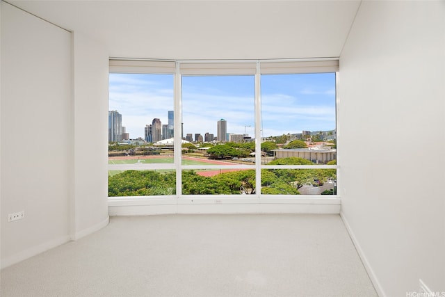 1288 Kapiolani Blvd Unit I-608, Honolulu, HI 96814 - spare room with a skyline view, carpet flooring, and plenty of natural light
