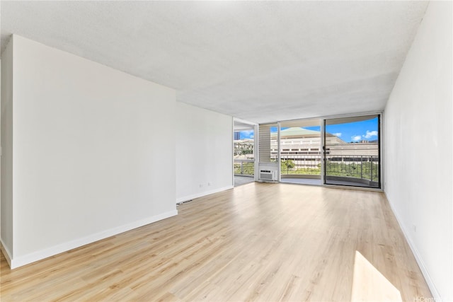 1717 Ala Wai Blvd Unit 701, Honolulu, HI 96815 - empty room with baseboards, light wood finished floors, and expansive windows