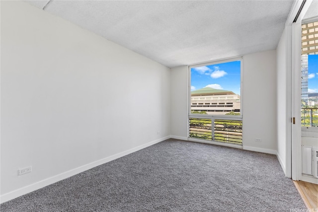 1717 Ala Wai Blvd Unit 701, Honolulu, HI 96815 - empty room featuring a textured ceiling, carpet floors, and baseboards