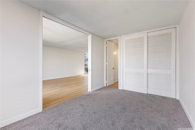 1717 Ala Wai Blvd Unit 701, Honolulu, HI 96815 - unfurnished bedroom featuring carpet flooring, baseboards, and a closet