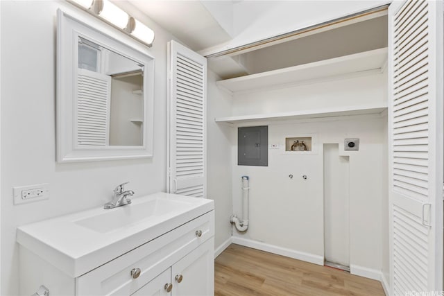 1717 Ala Wai Blvd Unit 701, Honolulu, HI 96815 - laundry area with hookup for an electric dryer, electric panel, washer hookup, light wood-type flooring, and baseboards
