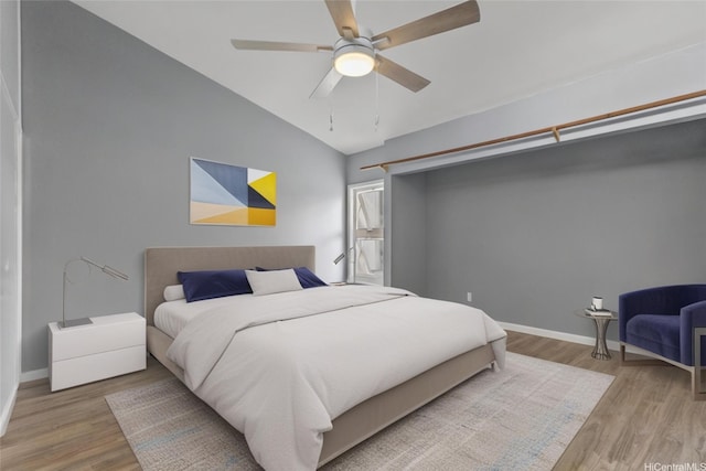 95-100 Moenamanu St Unit 458, Mililani, HI 96789 - bedroom featuring wood finished floors, vaulted ceiling, baseboards, and a ceiling fan