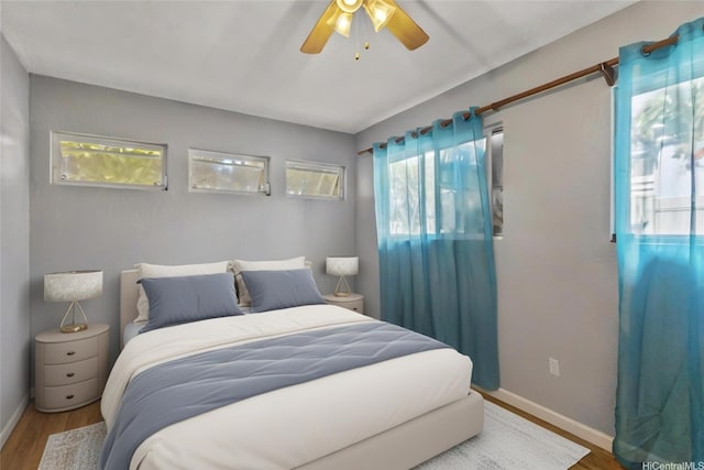 95-100 Moenamanu St Unit 458, Mililani, HI 96789 - bedroom featuring wood finished floors, multiple windows, baseboards, and ceiling fan