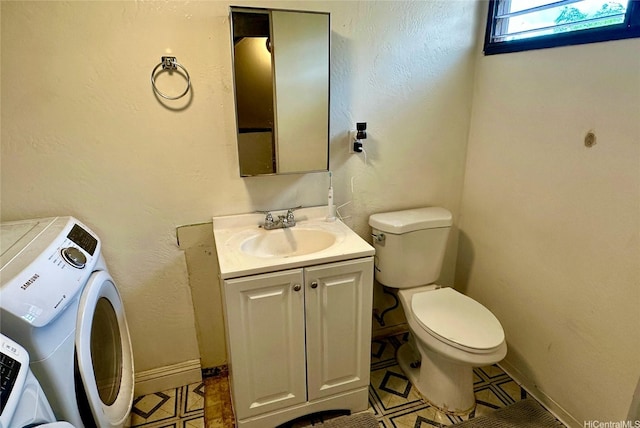 87217 Helelua St Unit 1, Waianae, HI 96792 - bathroom with toilet, washer / clothes dryer, vanity, and baseboards