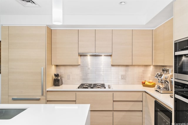 1108 Auahi St Unit 507, Honolulu, HI 96814 - kitchen with light brown cabinets, beverage cooler, appliances with stainless steel finishes, light countertops, and backsplash