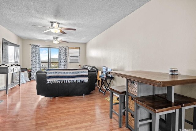 98-626 Moanalua Loop Unit 304, Aiea, HI 96701 - living room featuring ceiling fan, light wood-style floors, a textured ceiling, and cooling unit