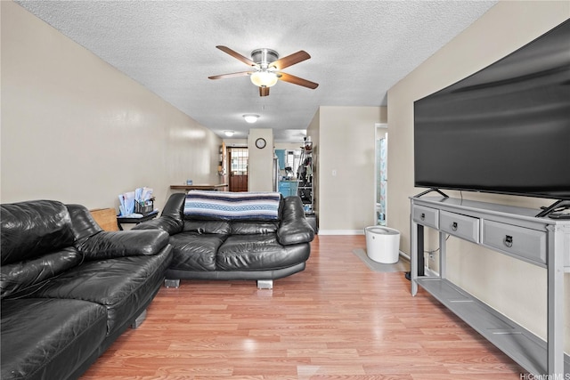 98-626 Moanalua Loop Unit 304, Aiea, HI 96701 - living area with ceiling fan, light wood-style floors, a textured ceiling, and baseboards