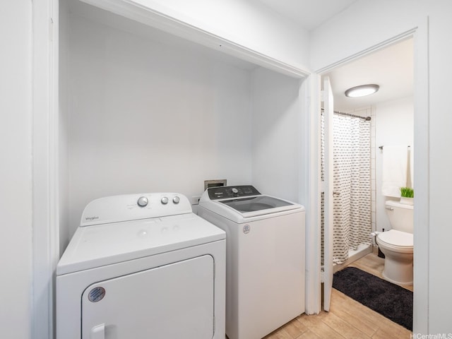 710 Lunalilo St Unit 402, Honolulu, HI 96813 - washroom featuring washer and dryer and light wood finished floors