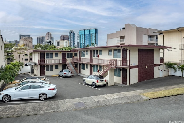 1408 Lusitana St, Honolulu, HI 96813 - view of property featuring stairway, a skyline view, and uncovered parking