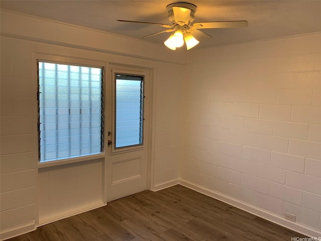 1408 Lusitana St, Honolulu, HI 96813 - unfurnished room featuring a ceiling fan, dark wood finished floors, concrete block wall, and baseboards