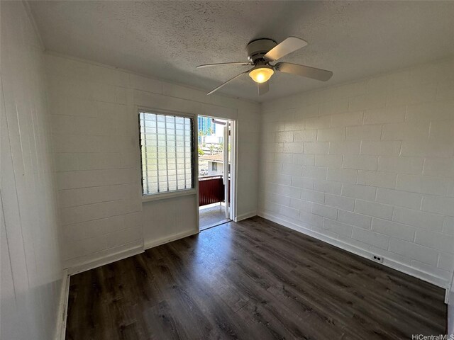 1408 Lusitana St, Honolulu, HI 96813 - empty room featuring ceiling fan, dark wood-style flooring, a textured ceiling, concrete block wall, and baseboards