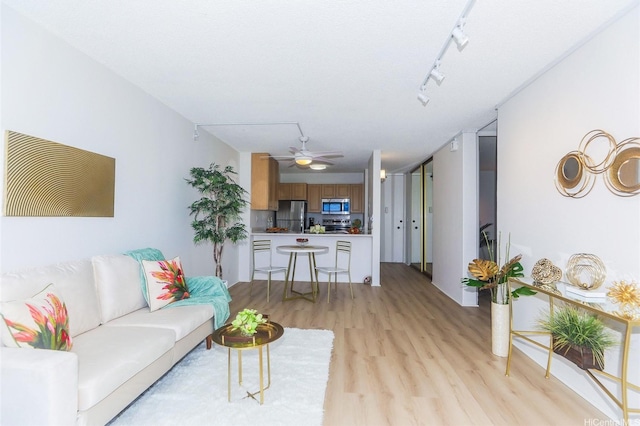 98-500 Koauka Loop Unit 23H, Aiea, HI 96701 - living area with light wood-type flooring and ceiling fan