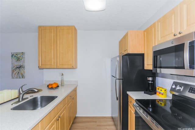 98-500 Koauka Loop Unit 23H, Aiea, HI 96701 - kitchen featuring stainless steel appliances, light wood-type flooring, light countertops, a textured ceiling, and light brown cabinets