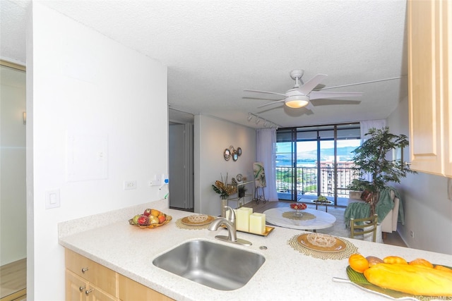 98-500 Koauka Loop Unit 23H, Aiea, HI 96701 - kitchen with a ceiling fan, a textured ceiling, light countertops, and light brown cabinetry