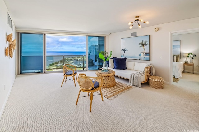 1177 Queen St Unit 4306, Honolulu, HI 96814 - carpeted living area with a chandelier, floor to ceiling windows, and a water view