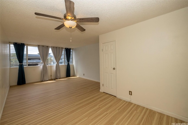 46-232 Kahuhipa St Unit B205, Kaneohe, HI 96744 - unfurnished room with light wood finished floors, a ceiling fan, baseboards, and a textured ceiling