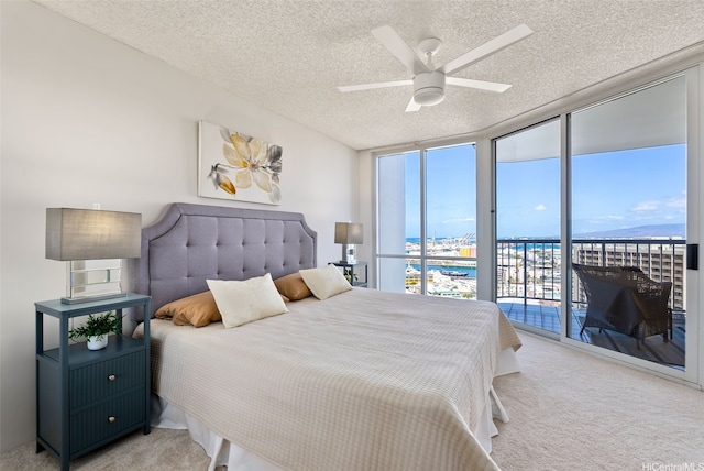 1212 Nuuanu Ave Unit 2509, Honolulu, HI 96817 - bedroom featuring floor to ceiling windows, light colored carpet, access to outside, a textured ceiling, and ceiling fan