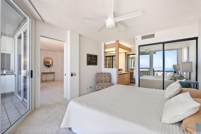 1212 Nuuanu Ave Unit 2509, Honolulu, HI 96817 - bedroom featuring access to exterior, light colored carpet, a textured ceiling, and a ceiling fan
