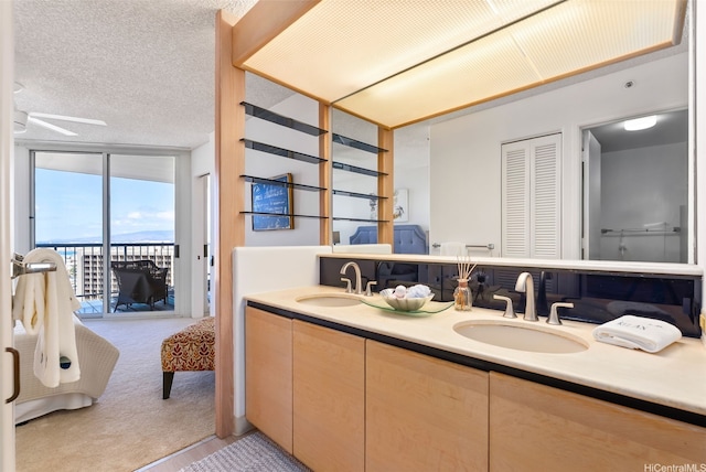 1212 Nuuanu Ave Unit 2509, Honolulu, HI 96817 - full bath with double vanity, expansive windows, a textured ceiling, and ceiling fan