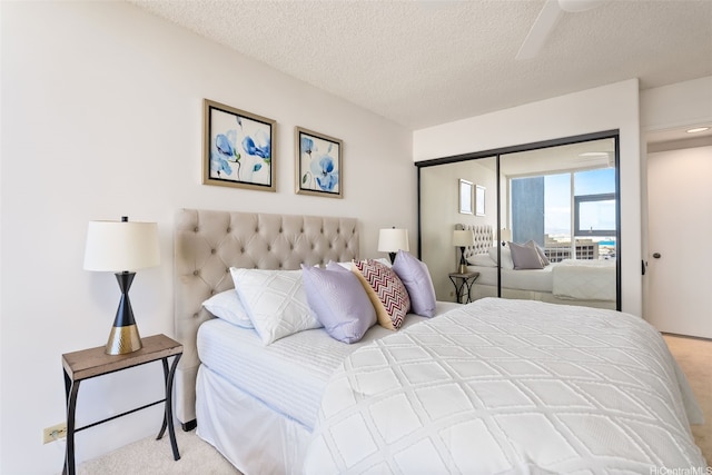 1212 Nuuanu Ave Unit 2509, Honolulu, HI 96817 - bedroom with light carpet, a textured ceiling, a closet, and ceiling fan