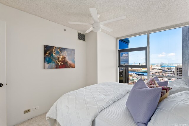 1212 Nuuanu Ave Unit 2509, Honolulu, HI 96817 - carpeted bedroom with expansive windows, a textured ceiling, and a ceiling fan