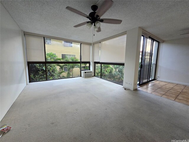 322 Aoloa St Unit 208, Kailua, HI 96734 - carpeted spare room with expansive windows, ceiling fan, a textured ceiling, and cooling unit