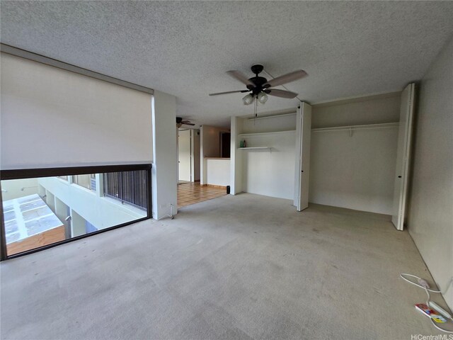 322 Aoloa St Unit 208, Kailua, HI 96734 - unfurnished bedroom featuring carpet floors, a textured ceiling, and a ceiling fan