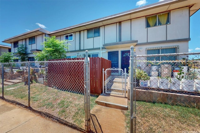 91-652 Kilaha St Unit A4, Ewa Beach, HI 96706 - view of front of house featuring board and batten siding and a gate