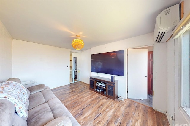 91-652 Kilaha St Unit A4, Ewa Beach, HI 96706 - living area featuring a wall mounted AC and wood finished floors
