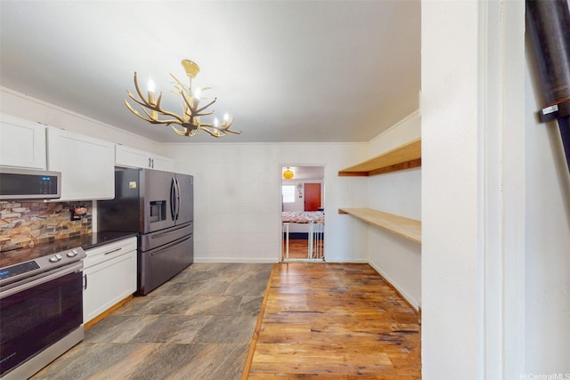 91-652 Kilaha St Unit A4, Ewa Beach, HI 96706 - kitchen with appliances with stainless steel finishes, a chandelier, white cabinets, and decorative backsplash