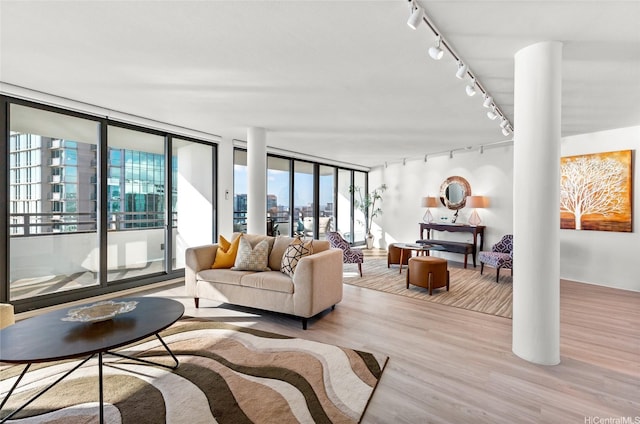 1330 Ala Moana Blvd Unit 3901, Honolulu, HI 96814 - living area featuring rail lighting, wood finished floors, and ornate columns