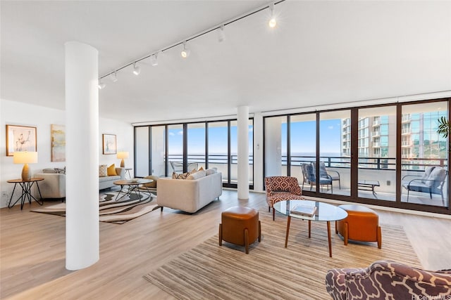 1330 Ala Moana Blvd Unit 3901, Honolulu, HI 96814 - living room with a wall of windows, wood finished floors, and rail lighting