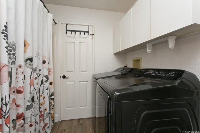94-1045 Paha Pl Unit T7, Waipahu, HI 96797 - laundry room with wood finished floors, washing machine and dryer, and cabinet space