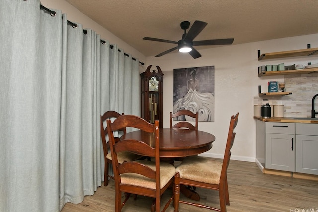 94-1045 Paha Pl Unit T7, Waipahu, HI 96797 - dining space with light wood-style flooring, a ceiling fan, and a textured ceiling