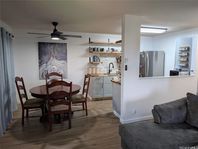 94-1045 Paha Pl Unit T7, Waipahu, HI 96797 - dining room featuring dark wood-style flooring, a ceiling fan, and a textured ceiling