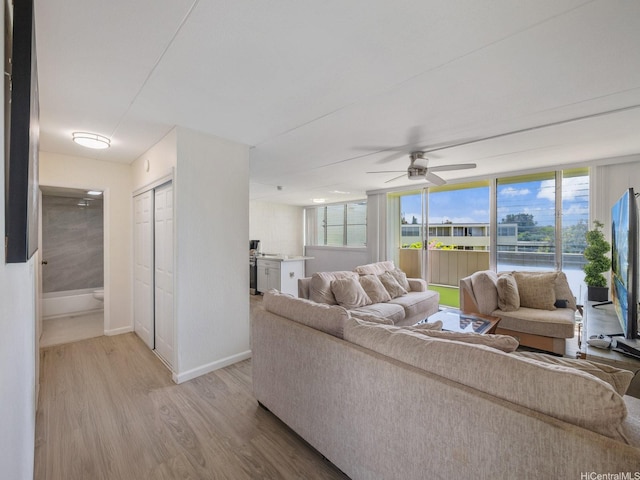 95-31 Kuahelani Ave Unit 439, Mililani, HI 96789 - living room with light wood-type flooring, baseboards, a ceiling fan, and a water view