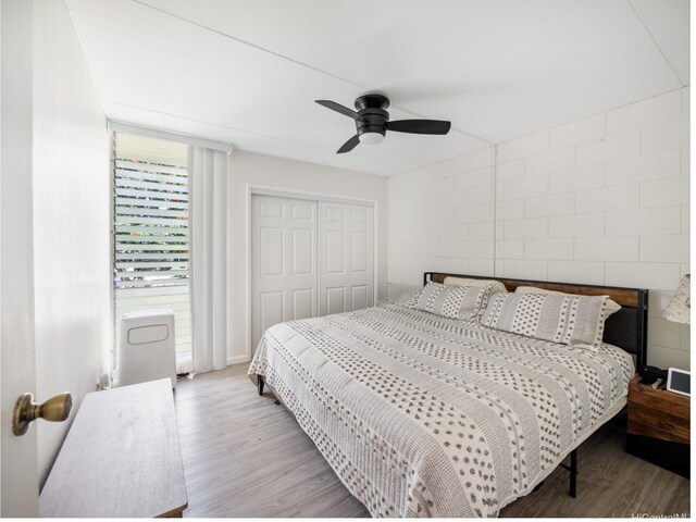 95-31 Kuahelani Ave Unit 439, Mililani, HI 96789 - bedroom featuring wood finished floors, a closet, a ceiling fan, and baseboards