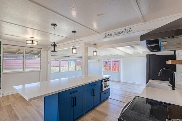 91-517 Pohakupuna Rd, Ewa Beach, HI 96706 - kitchen featuring blue cabinetry, light wood finished floors, light countertops, freestanding refrigerator, and range hood