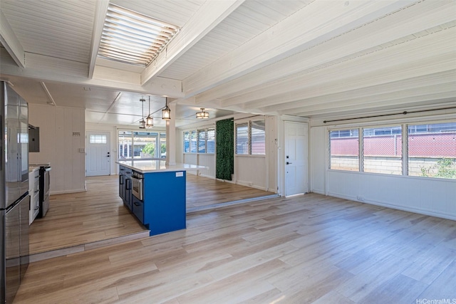 91-517 Pohakupuna Rd, Ewa Beach, HI 96706 - kitchen featuring blue cabinetry, appliances with stainless steel finishes, light countertops, light wood-style floors, and beamed ceiling