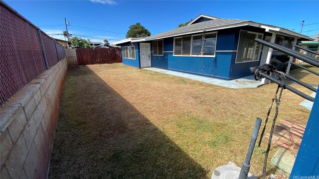 91-517 Pohakupuna Rd, Ewa Beach, HI 96706 - view of property exterior with a fenced backyard and roof with shingles