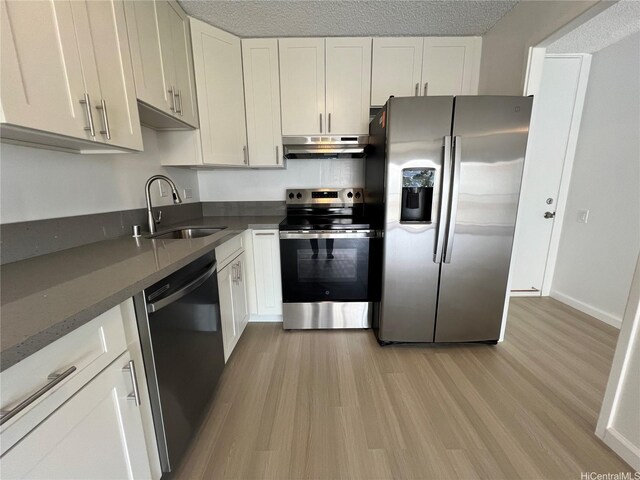 909 Ala Lilikoi St Unit 505, Honolulu, HI 96818 - kitchen featuring appliances with stainless steel finishes, under cabinet range hood, light wood finished floors, and white cabinetry