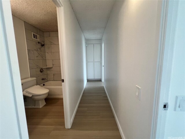 909 Ala Lilikoi St Unit 505, Honolulu, HI 96818 - full bath with wood finished floors, a textured ceiling, and shower / washtub combination