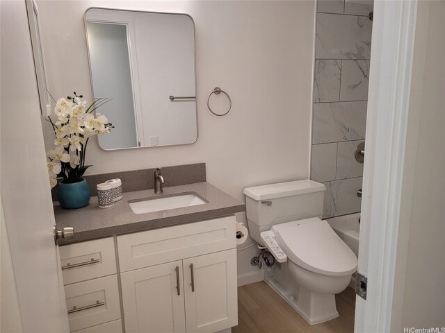 909 Ala Lilikoi St Unit 505, Honolulu, HI 96818 - bathroom featuring vanity, wood finished floors, and shower / bathtub combination