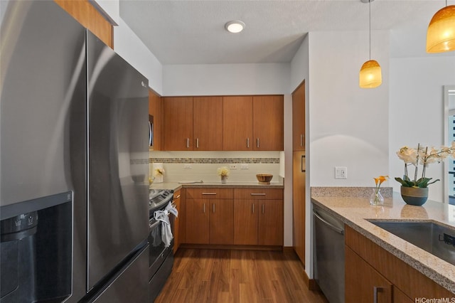 555 S St Unit 2201, Honolulu, HI 96813 - kitchen with stainless steel appliances, brown cabinets, dark wood finished floors, and light stone countertops